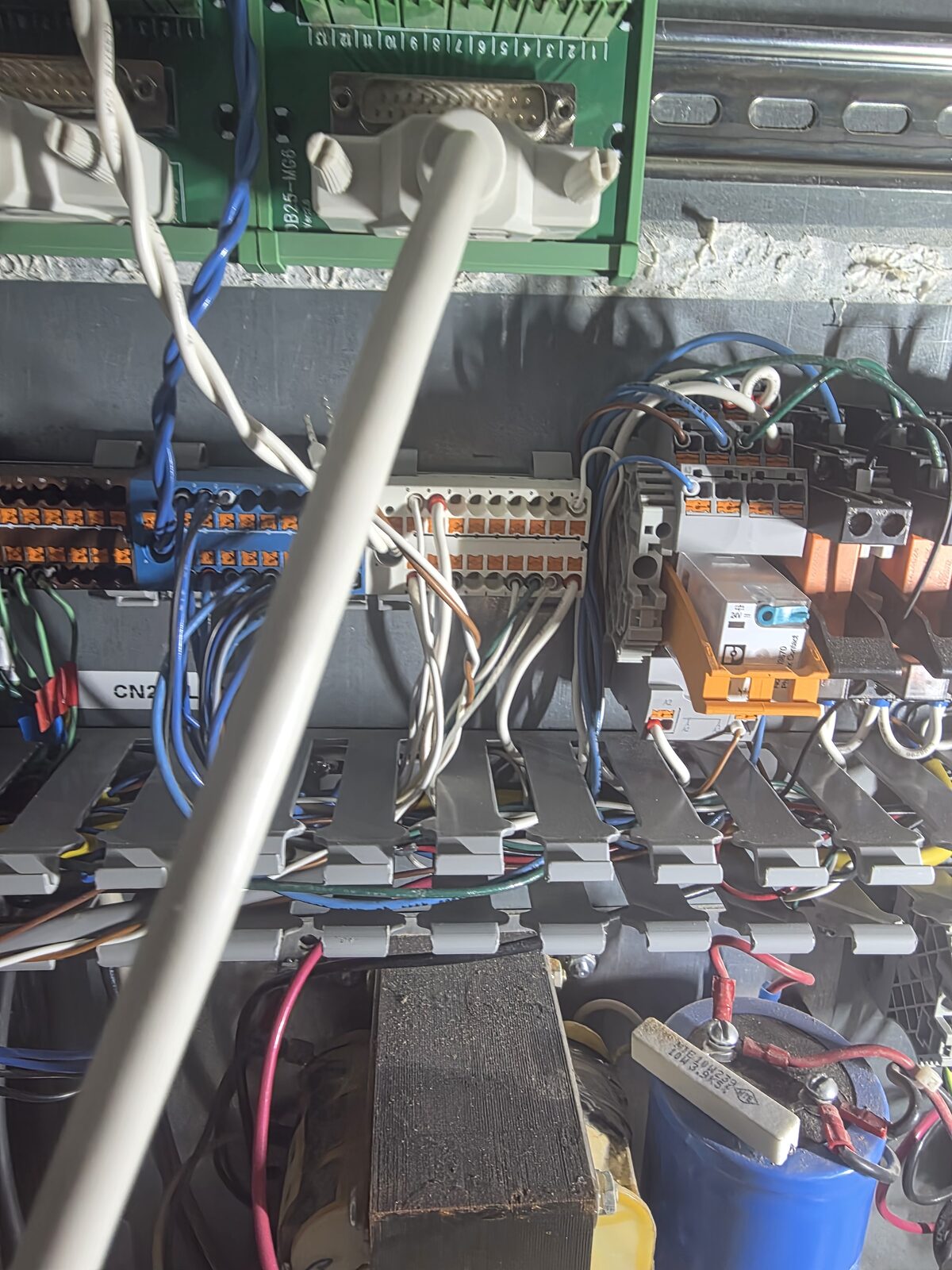 The control cabinet mid-retrofit — Field I/O boards and the analog spindle interface